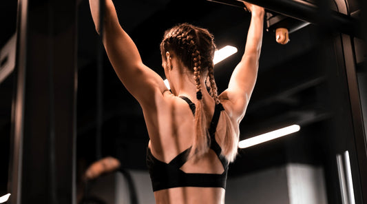 Fit woman training in gym, wearing posture bra for support and performance.
