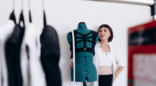 Founder of Etalon showcasing the brand’s posture bra for back pain relief and posture support.