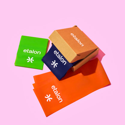 A bundle of green, blue, and orange Etalon posture support bands.