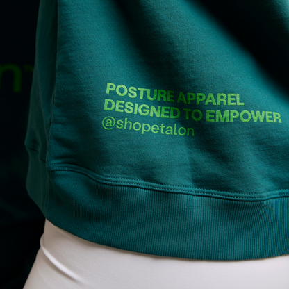 A close-up of the Etalon sweatshirt’s back, showing empowering text near the shoulders.